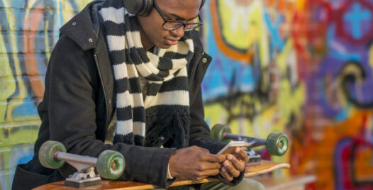 A young man shopping online on a mobile device