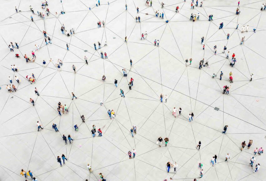 People on a gray surface connected by network lines indicating a real-time payment network