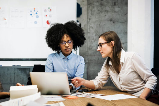 Two women use a payment orchestration platform