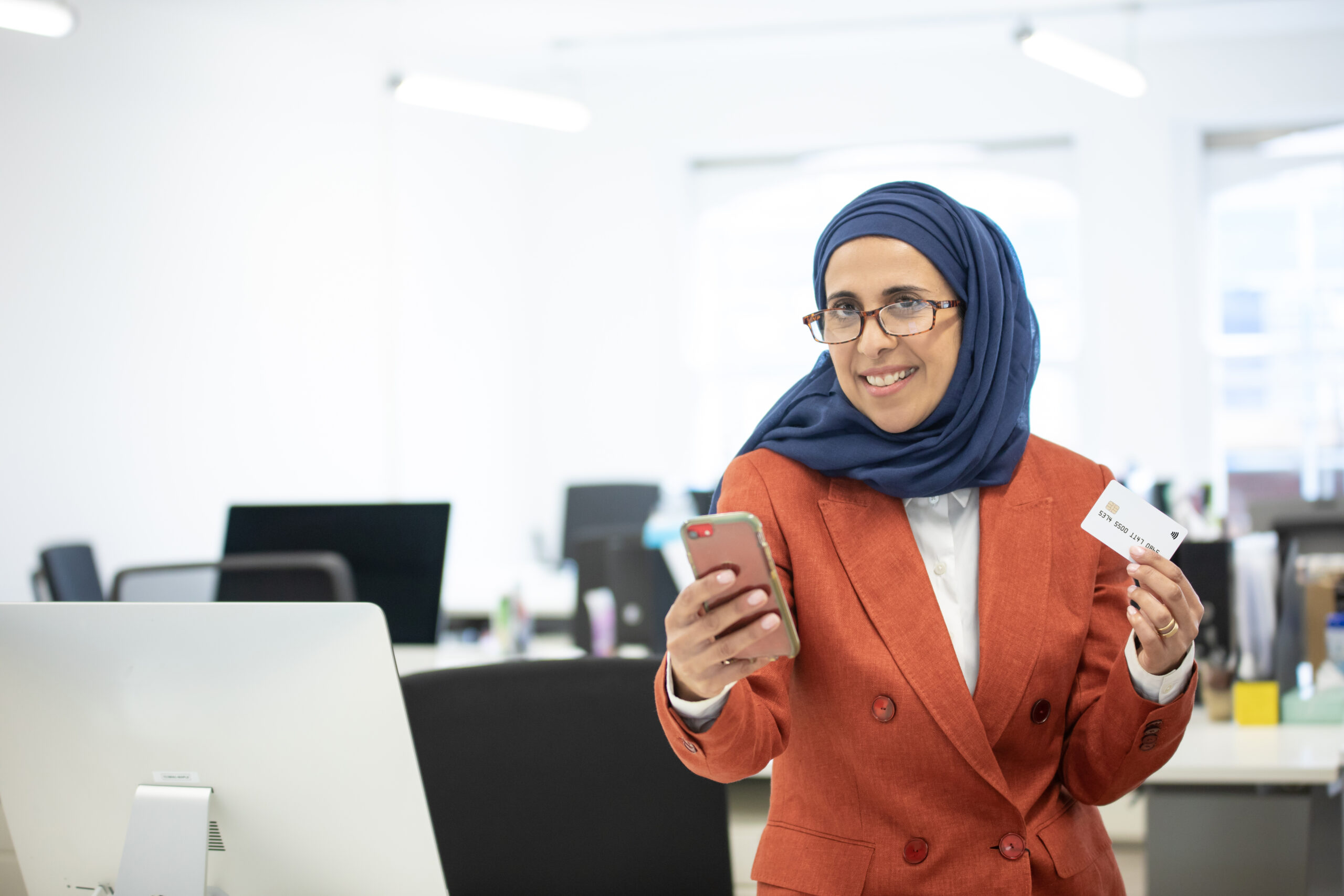 Woman with headcovering with Credit Card